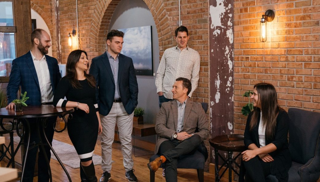 Six people converse in a business setting