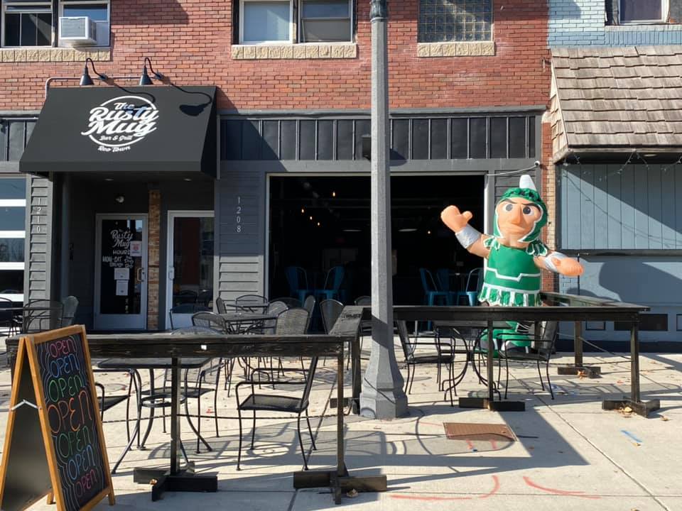 An inflatable Sparty waves outside the Rusty Mug's patio