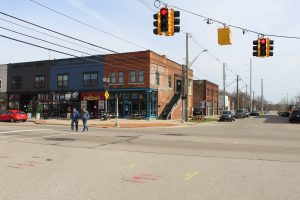 Two men cross the street on Washington Ave.